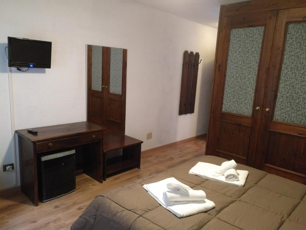 Postel nebo postele na pokoji v ubytování Hotel I Larici
