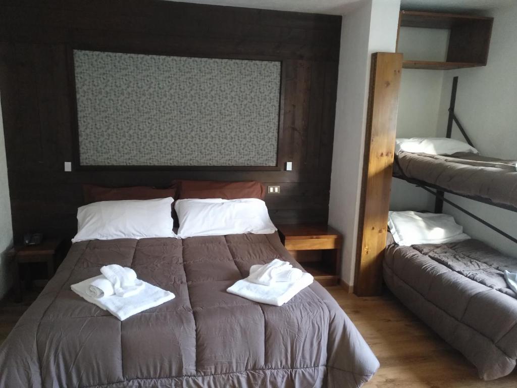 Postel nebo postele na pokoji v ubytování Hotel I Larici