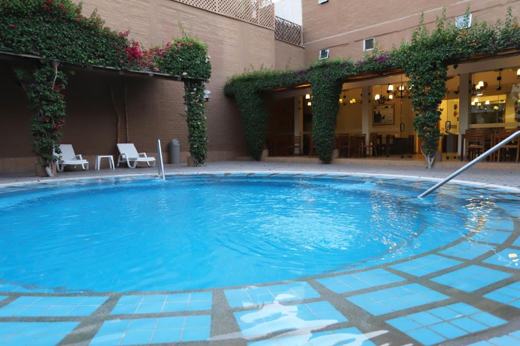 a large swimming pool in the middle of a building at Casa Andina Standard Nasca in Nazca