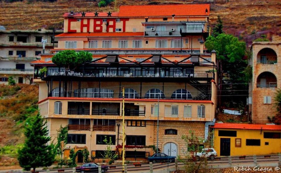 a large building with balconies on the side of it at Hotel Chbat in Bcharré