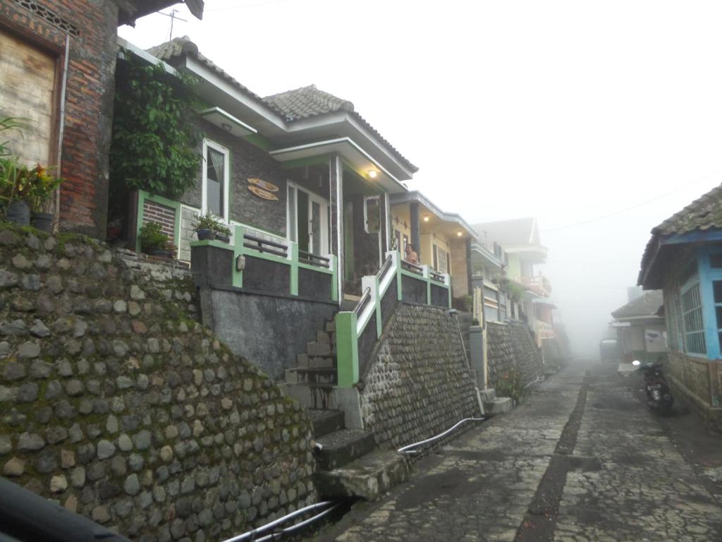 a foggy street with a row of houses at Villa Anna in Bromo