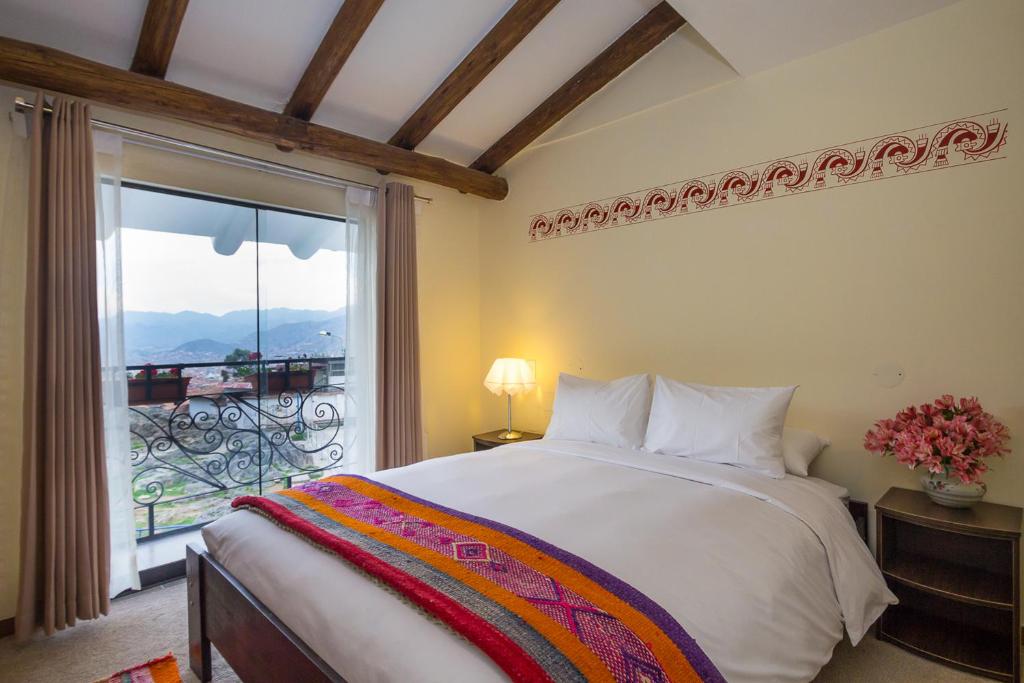 Postel nebo postele na pokoji v ubytování Luna House Cusco