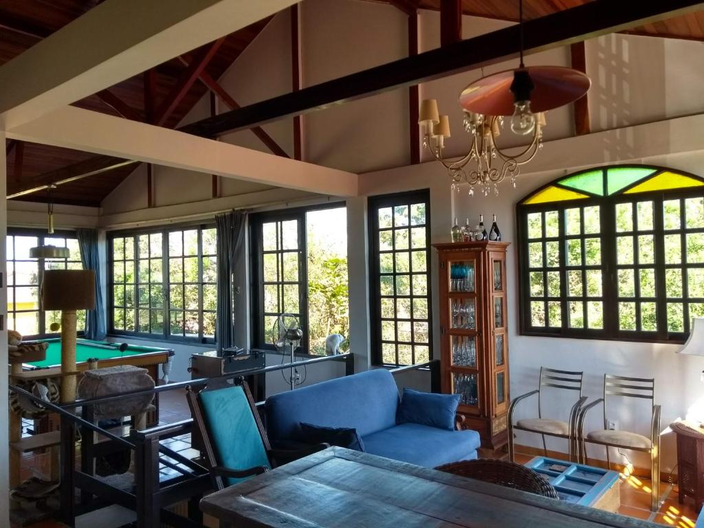 a living room with a pool table and windows at The Cats' House in Florianópolis