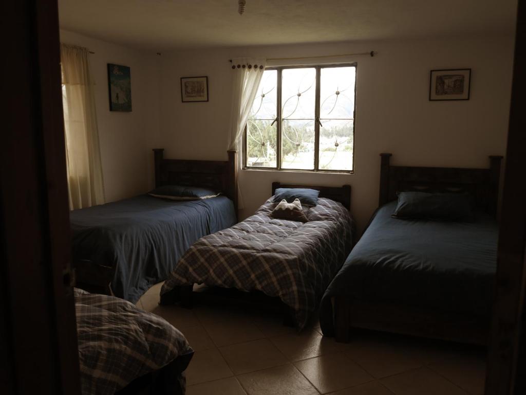 Postel nebo postele na pokoji v ubytování Hostal Casa Lantana