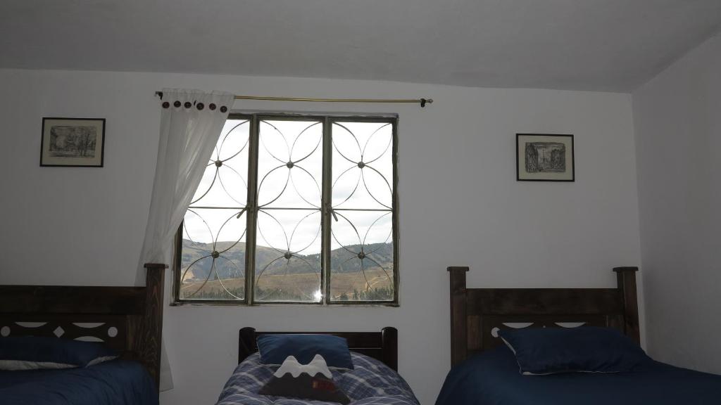 Postel nebo postele na pokoji v ubytování Hostal Casa Lantana
