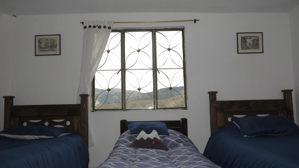 Postel nebo postele na pokoji v ubytování Hostal Casa Lantana