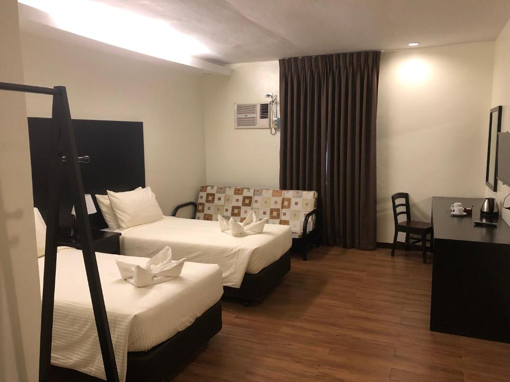 Postel nebo postele na pokoji v ubytování Piña Suites