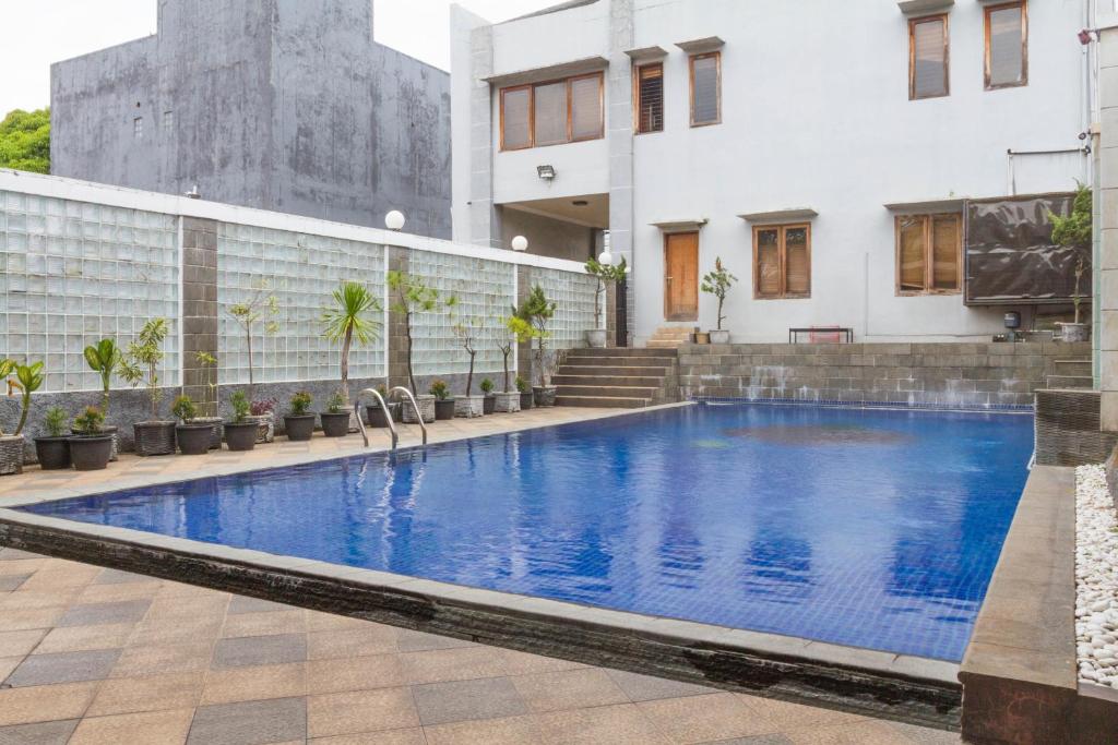 a swimming pool in front of a building at RedDoorz near Jatinangor Town Square in Jatinangor