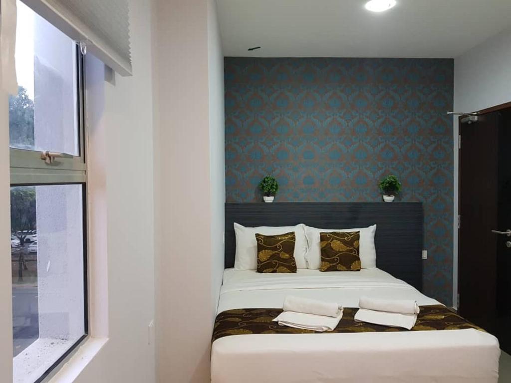 Postel nebo postele na pokoji v ubytování D'Metro Hotel