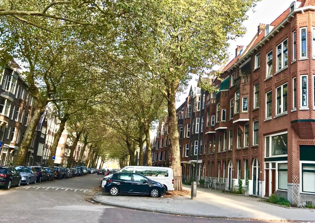 a city street with cars parked on the street at Bed and Breakfast Rotterdam in Rotterdam
