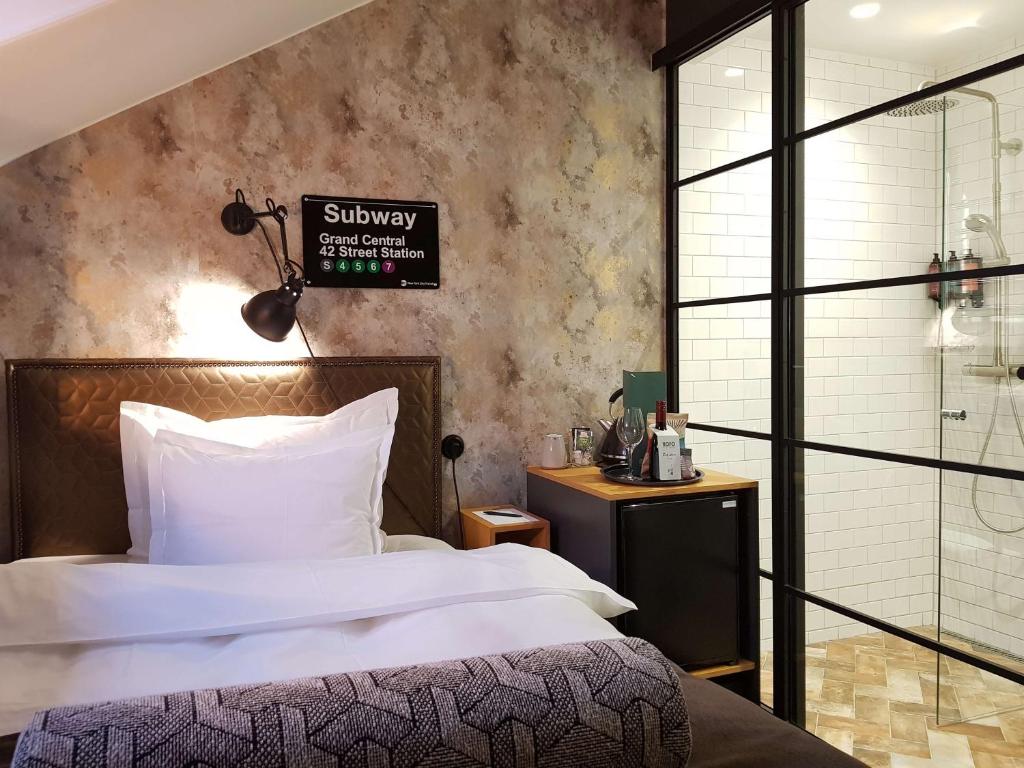 Postel nebo postele na pokoji v ubytování NOFO Hotel, WorldHotels Crafted