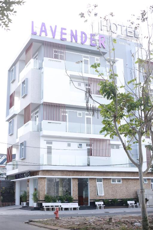 a large white building with a sign on it at Lavender Hotel in Can Tho