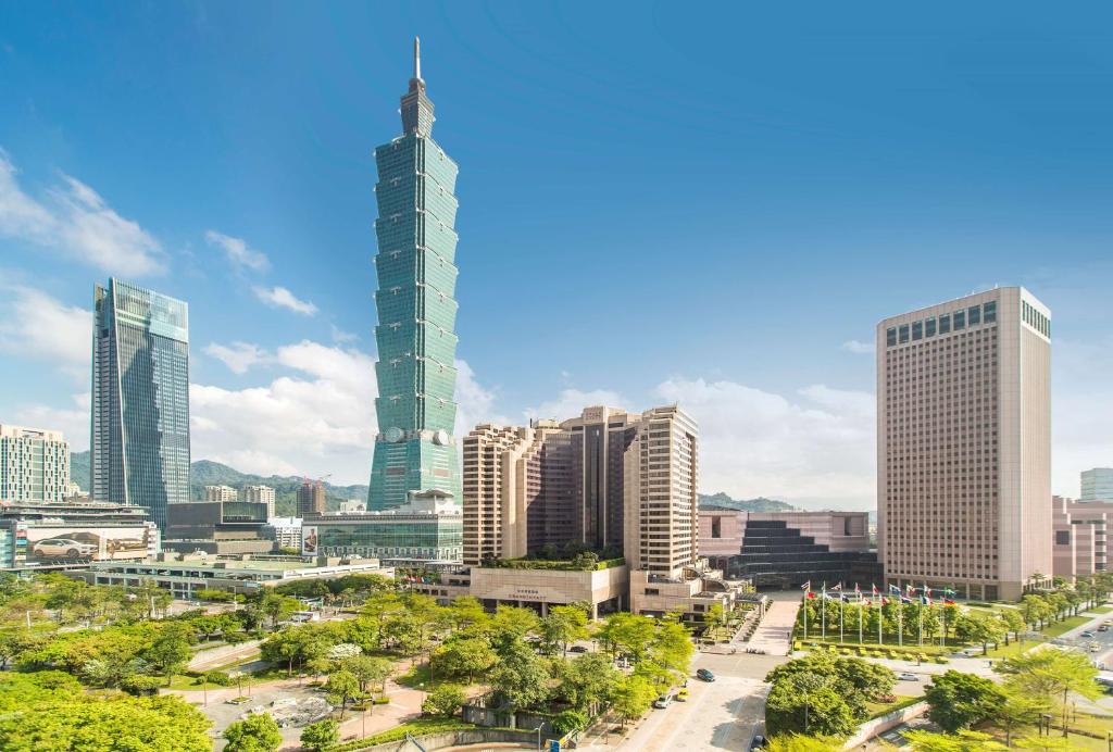 a city with tall buildings and a clock tower at Grand Hyatt Taipei in Taipei