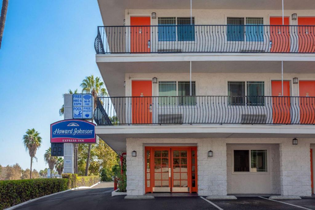 - un bâtiment avec une porte rouge et un balcon dans l'établissement Howard Johnson by Wyndham San Diego Hotel Circle, à San Diego