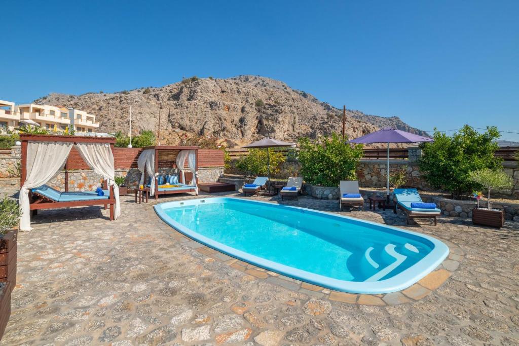 a swimming pool in the middle of a patio at Maripaul Family Villa in Lartos