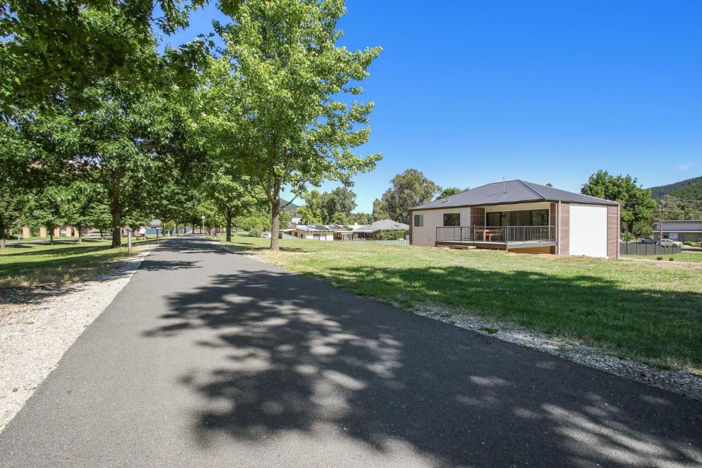 a road with a house and trees and a building at BrightAway in Bright