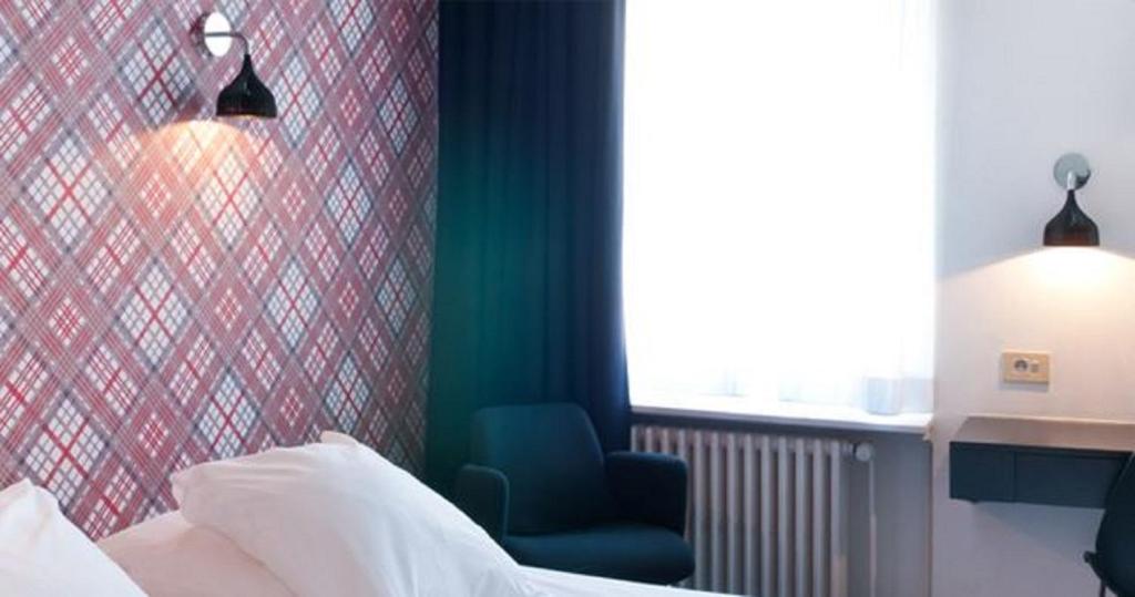 Postel nebo postele na pokoji v ubytování Hotel Queen Anne
