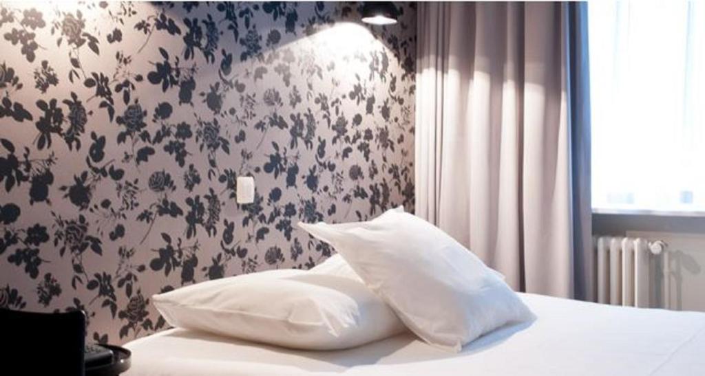 Postel nebo postele na pokoji v ubytování Hotel Queen Anne