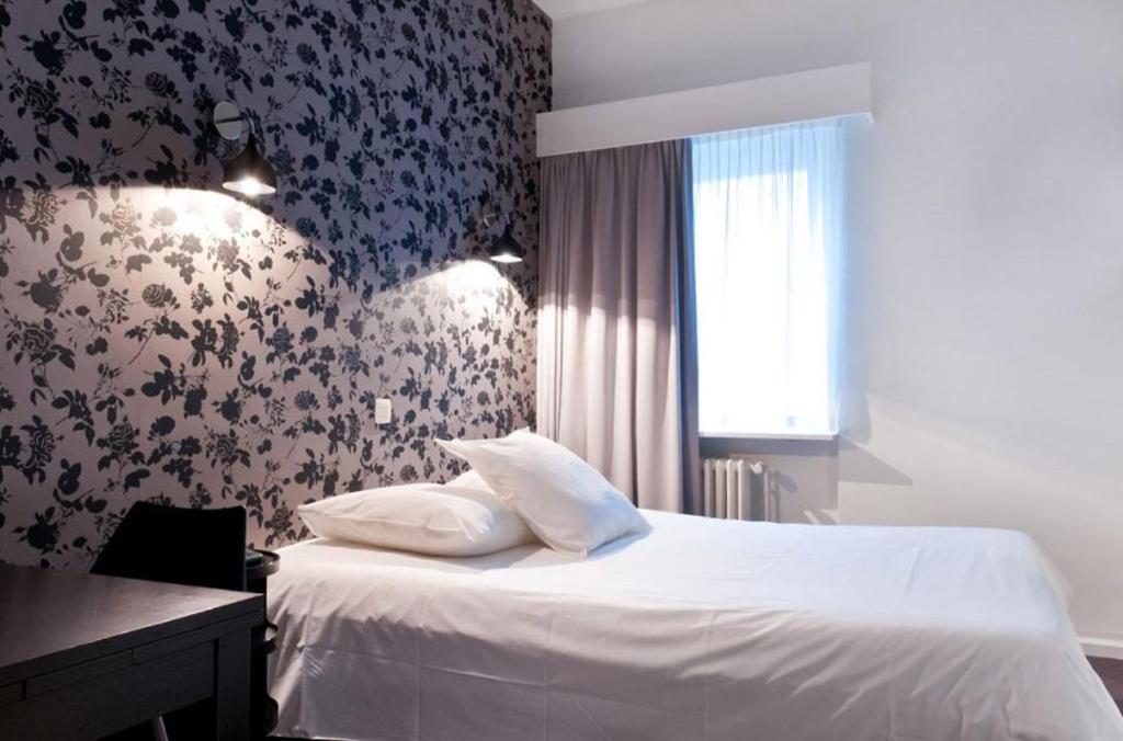 Postel nebo postele na pokoji v ubytování Hotel Queen Anne