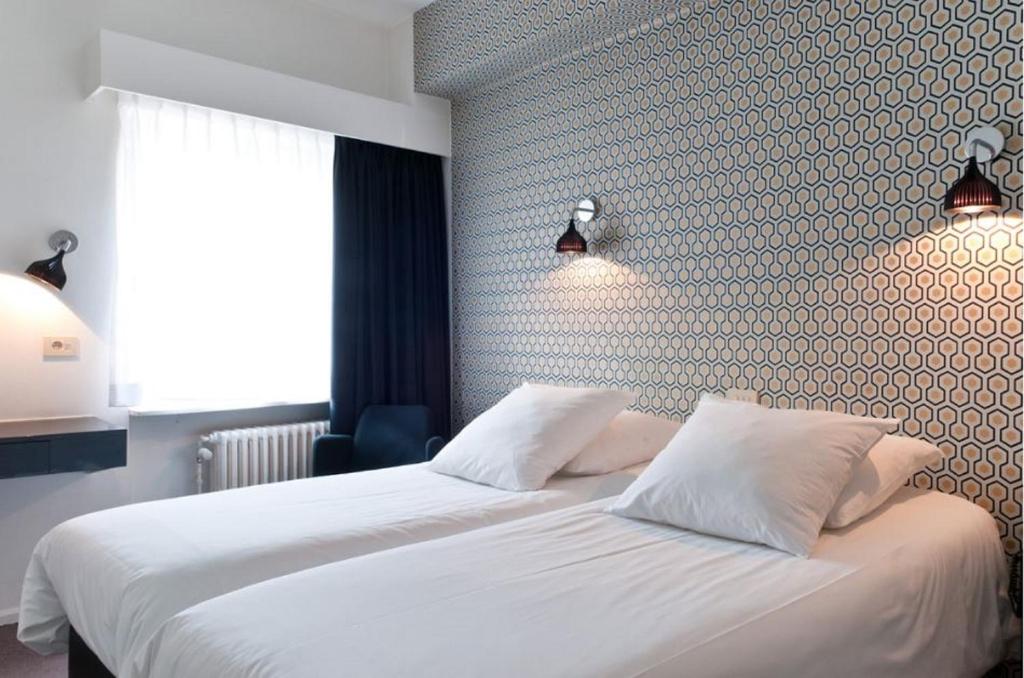 Postel nebo postele na pokoji v ubytování Hotel Queen Anne
