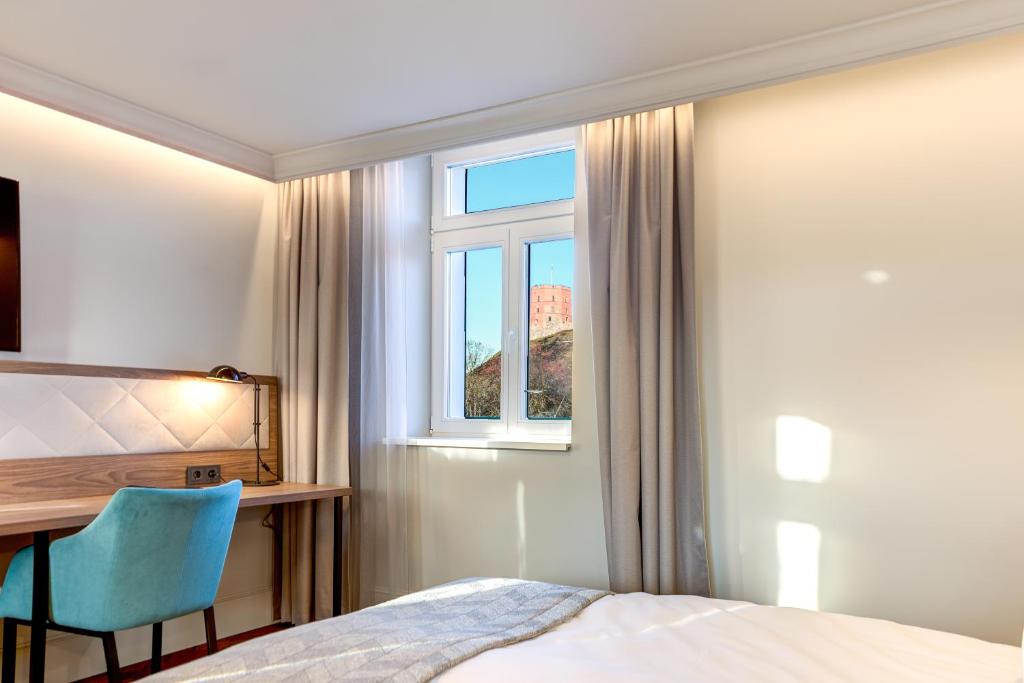 Postel nebo postele na pokoji v ubytování Hotel Vilnia