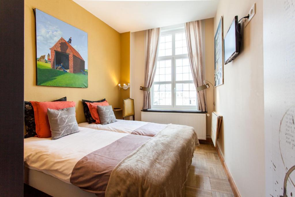 Postel nebo postele na pokoji v ubytování Hotel Het Wethuys