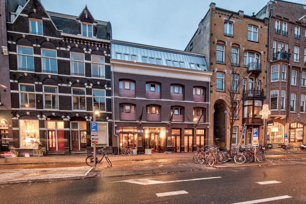 un groupe de bâtiments avec des vélos garés dans une rue dans l'établissement Hotel van de Vijsel, à Amsterdam