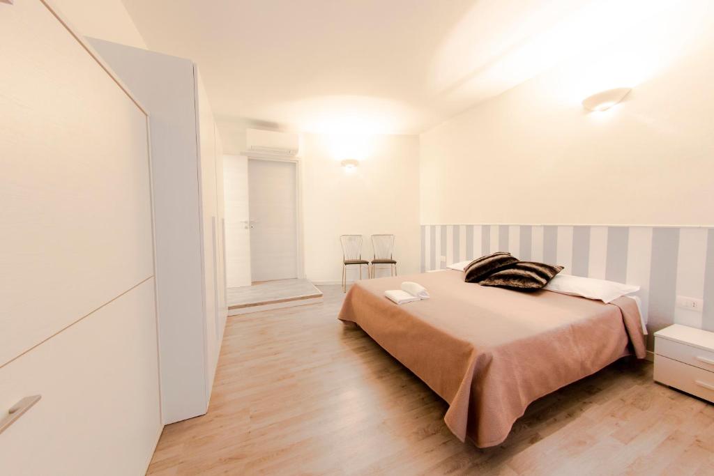 a bedroom with a bed in a white room at Business centro fiera in Verona