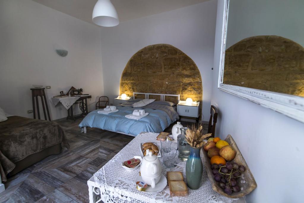 a bedroom with a bed and a table with food on it at Zabbara in Agrigento