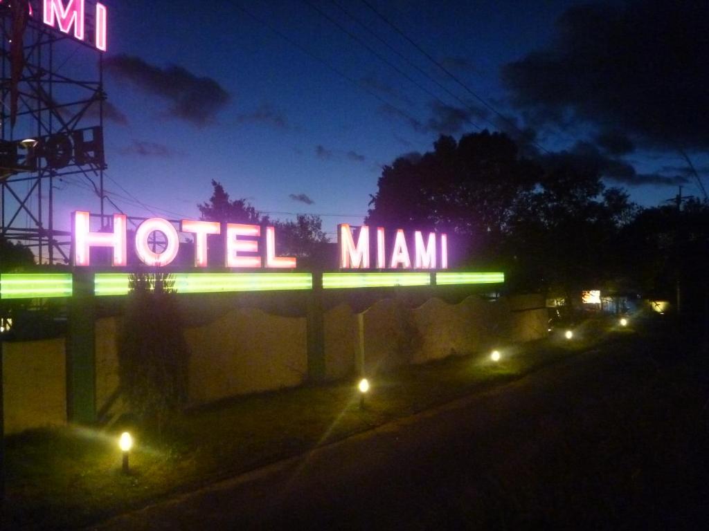 a neon hotel miami sign at night at Hotel Miami (Adult Only) in Metabaru