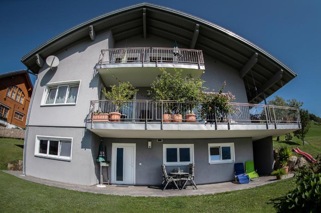 ein Gebäude mit einem Balkon mit Pflanzen in der Unterkunft Ferienwohnung Julia in Bartholomäberg