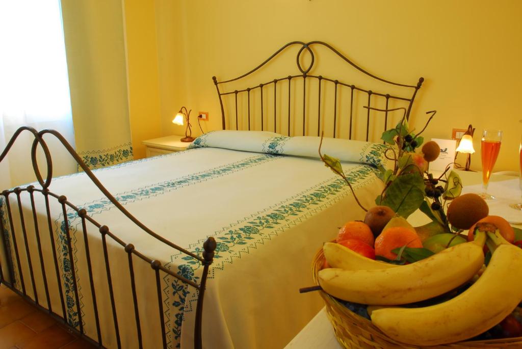A bed or beds in a room at LE NEREIDI Hotel & Residence con Piscina-Tennis-Fitness-Parcheggio coperto-Sala Conferenze