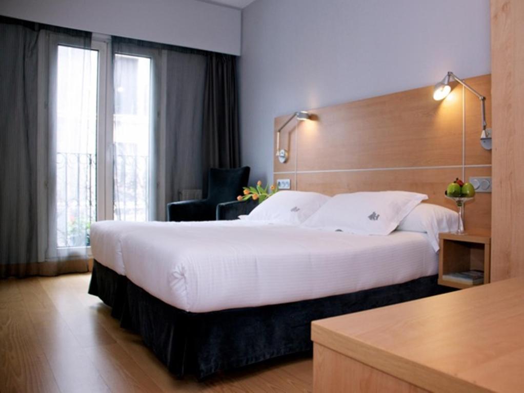 Postel nebo postele na pokoji v ubytování Hotel Jauregui