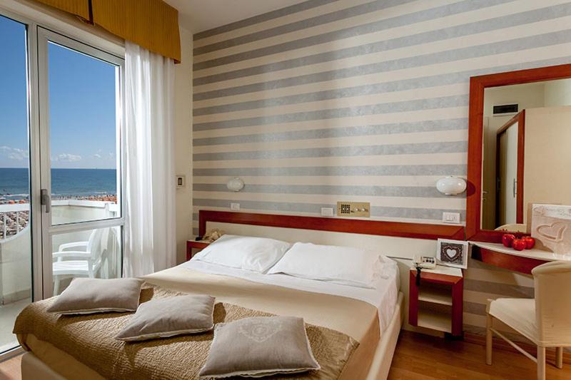 Postel nebo postele na pokoji v ubytování Hotel Aristeo