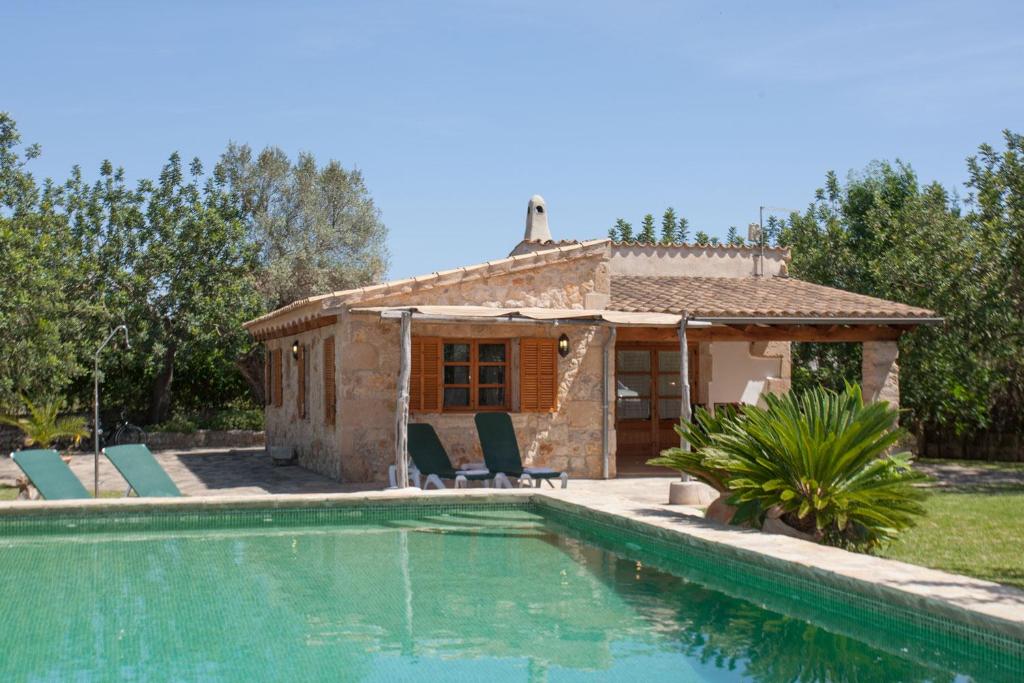 a villa with a swimming pool and a house at Villa Can Eli by SunVillas Mallorca in Pollença