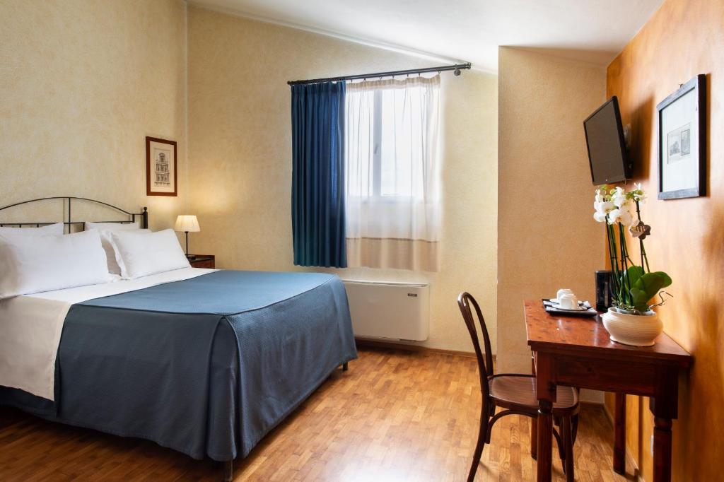 Postel nebo postele na pokoji v ubytování Hotel L'Antico Pozzo