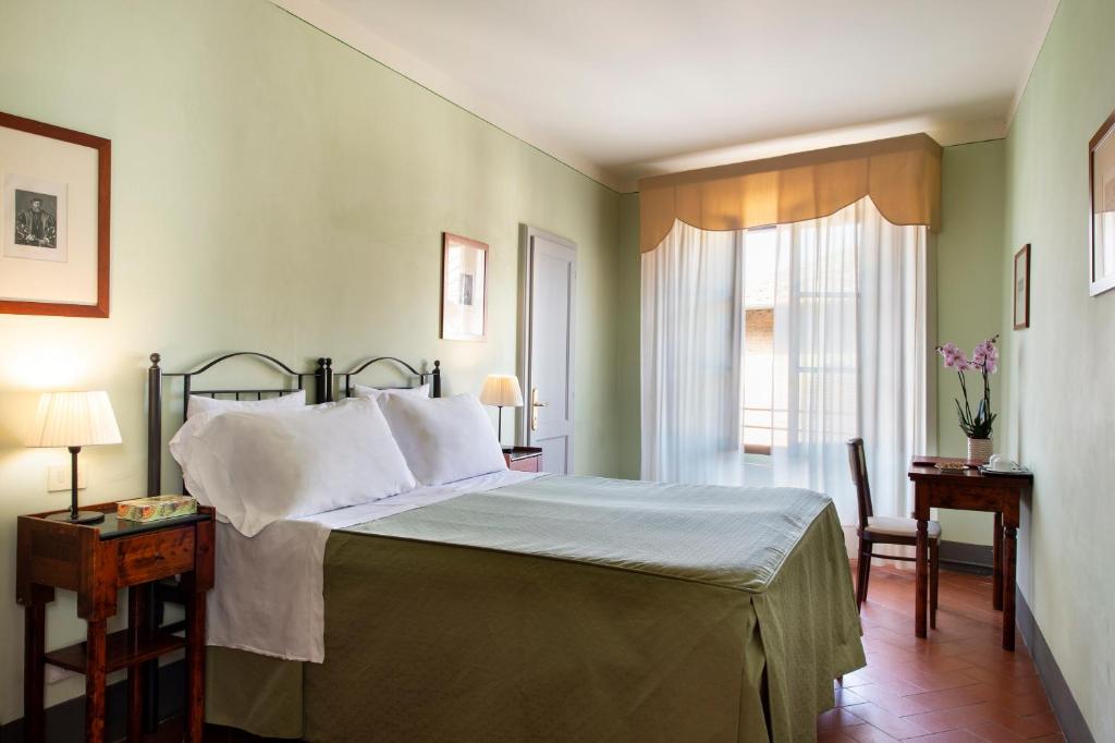 Postel nebo postele na pokoji v ubytování Hotel L'Antico Pozzo