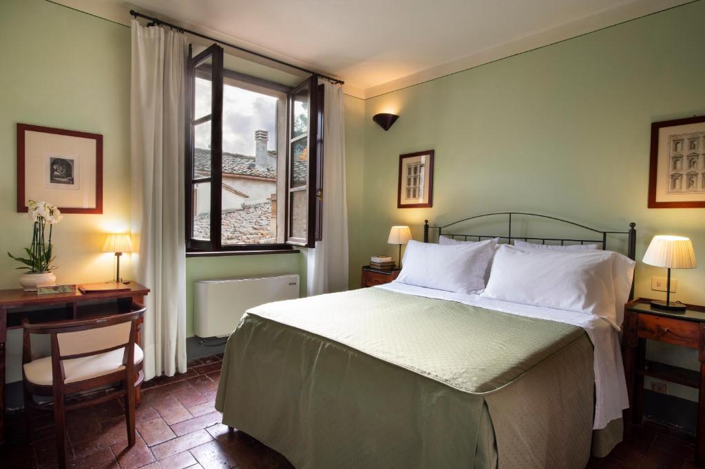 Postel nebo postele na pokoji v ubytování Hotel L'Antico Pozzo