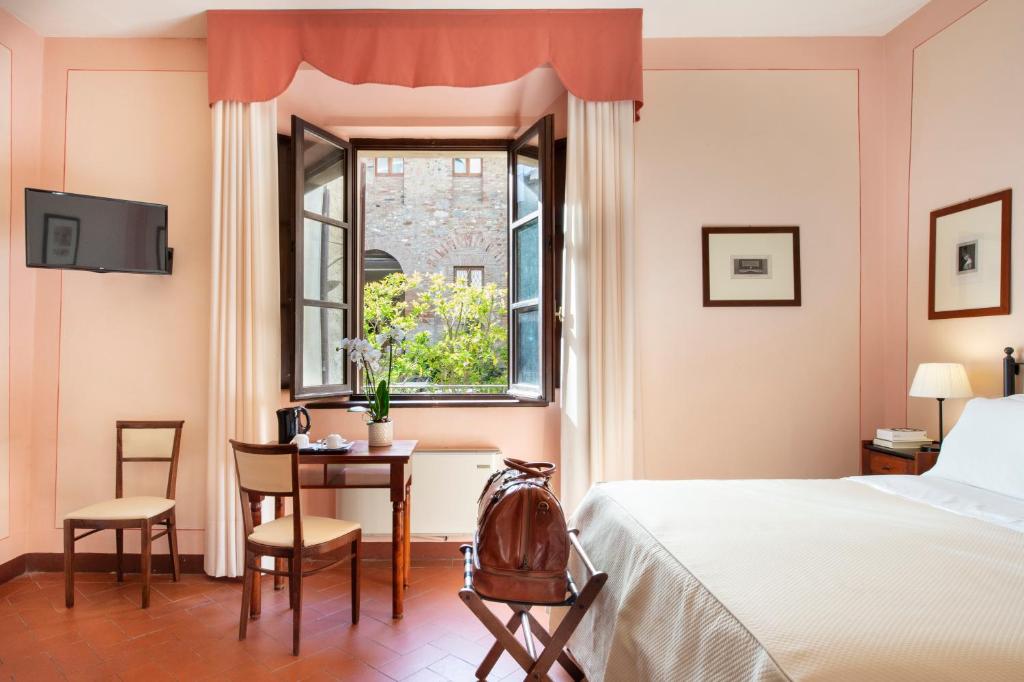 Postel nebo postele na pokoji v ubytování Hotel L'Antico Pozzo