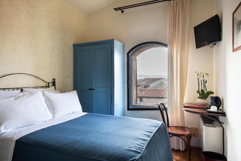 Postel nebo postele na pokoji v ubytování Hotel L'Antico Pozzo