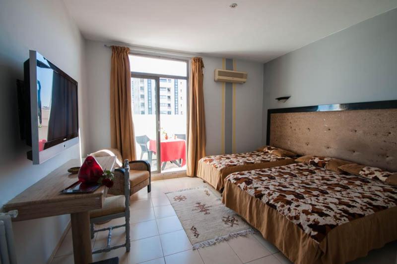 Postel nebo postele na pokoji v ubytování Hotel De La Paix