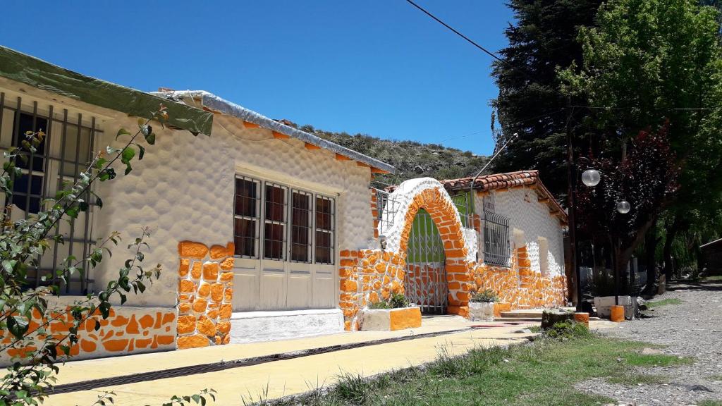 a small house with an orange and white facade at Hospedaje Don Alberto in Potrerillos