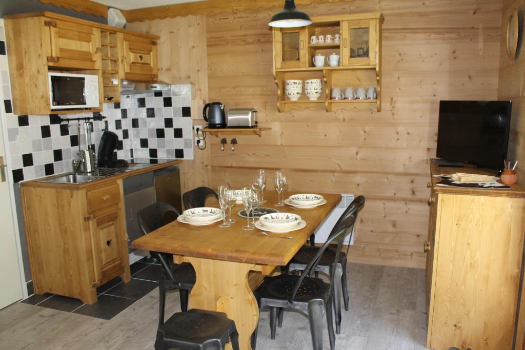 a kitchen with a wooden table in a room at L'Enclave in Les Contamines-Montjoie