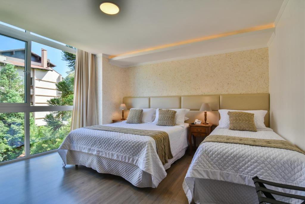 מיטה או מיטות בחדר ב-Micheline Hotel Tricot - ao lado da Rua Coberta