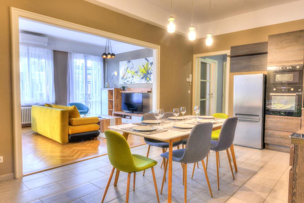 a kitchen and living room with a table and chairs at Central Downtown Apartments in Budapest