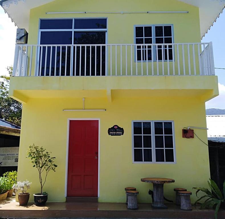 a yellow and red house with a red door at M's Place Chalet Bed&Breakfast in George Town