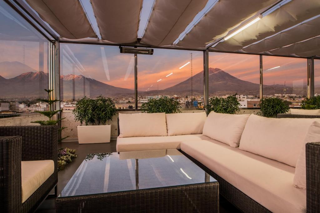 a living room with a couch and a table at Hotel Viza in Arequipa