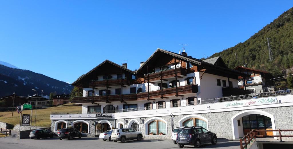 a large building with cars parked in front of it at Residence Fior d'Alpe in Valdidentro
