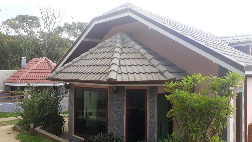 a small house with a pitched roof at Cantinho do Baianinho in Campos do Jordão