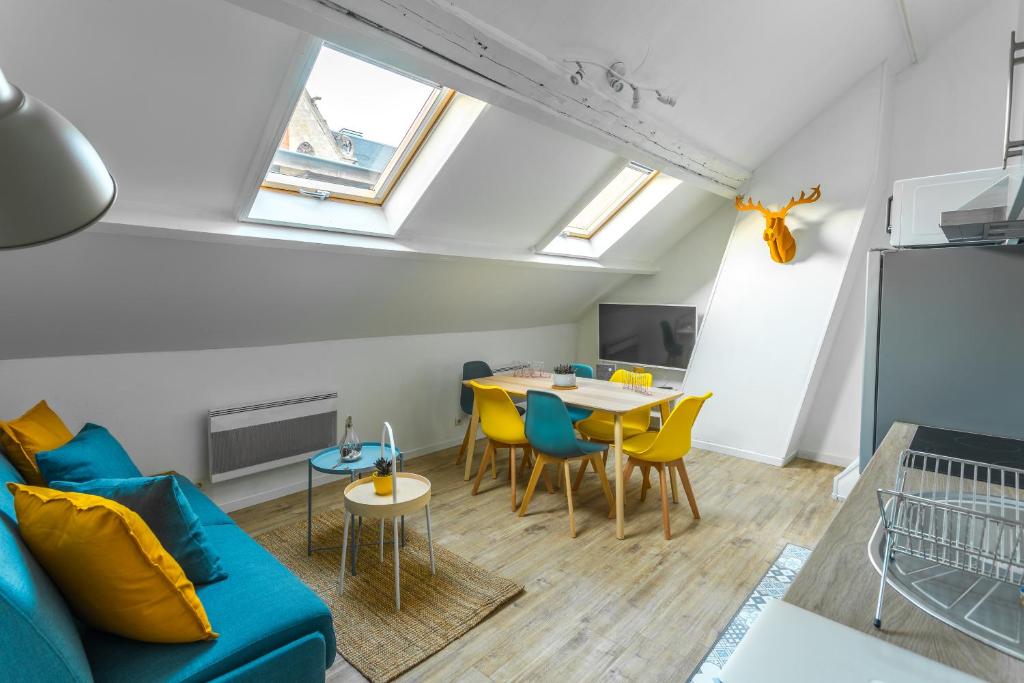 a living room with a couch and a table at Les Augustins in Amiens